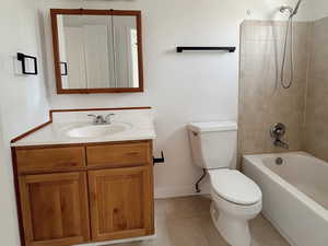 Full bath featuring toilet, shower / bath combination, vanity, tile patterned flooring, and baseboards