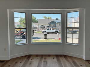 Unfurnished dining area with wood finished floors and baseboards