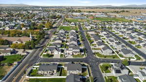 Aerial overview of property's location with nearby suburban area and a mountain backdrop