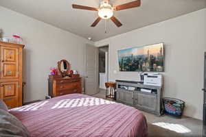 Bedroom with carpet floors, ceiling fan, and baseboards