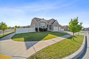 Traditional home featuring stone siding, concrete driveway, an attached garage, and stucco siding