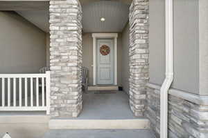 View of exterior entry featuring stone siding