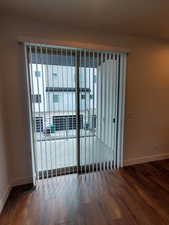 Empty room featuring wood finished floors and baseboards