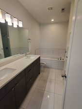 Bathroom with double vanity, a garden tub, tile patterned flooring, toilet, and a stall shower