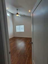 Unfurnished room featuring recessed lighting, ceiling fan, dark wood-type flooring, and baseboards