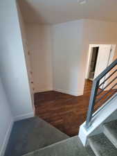 Stairs featuring baseboards and wood finished floors