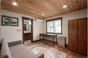 Foyer featuring recessed lighting, a wall mounted air conditioner, wood finished floors, baseboards, and wood ceiling