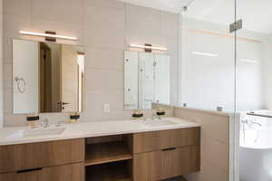 Bathroom with double vanity and a bathtub