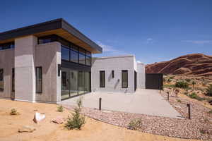 Rear view of property featuring a mountain view and a patio