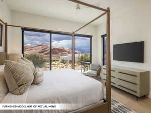 Bedroom featuring light wood-style floors, access to outside, ceiling fan, and baseboards