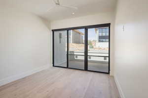 Empty room with wood finished floors, baseboards, ceiling fan, and recessed lighting