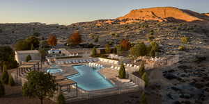 Community pool featuring a patio area, a community hot tub, a mountain view, and a pergola