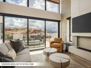 Living room featuring a high ceiling and wood finished floors