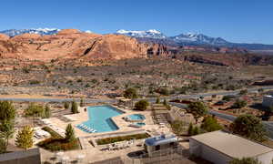 Aerial view of a pool area and a mountain backdrop