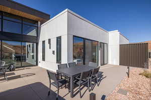 View of patio / terrace featuring outdoor dining area and a sunroom