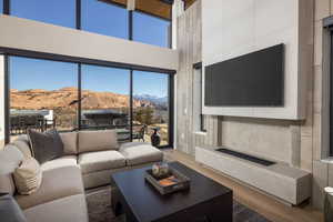 Living area featuring a towering ceiling and wood finished floors