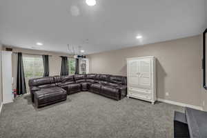 Living area featuring carpet flooring and recessed lighting