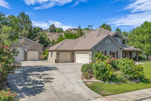 View of front of property featuring concrete driveway, a garage, stucco siding, a tiled roof, and a front lawn