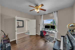 Home office with a ceiling fan and wood finished floors