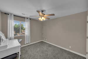 Unfurnished office with ceiling fan and carpet floors