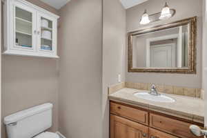 Half bathroom featuring toilet and vanity