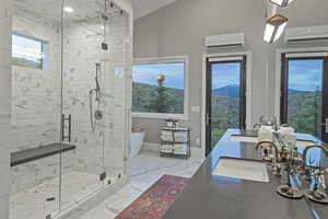 Full bathroom with a wall unit AC, a soaking tub, marble finish flooring, a stall shower, and double vanity