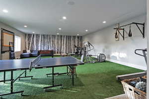 Recreation room with carpet floors, recessed lighting, and baseboards