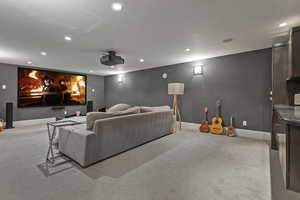 Cinema with recessed lighting, light colored carpet, and baseboards