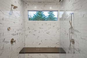 Bathroom with a tile shower and plenty of natural light
