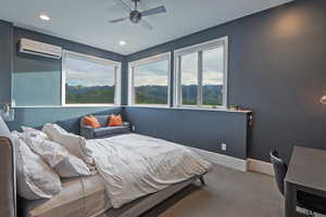 Bedroom featuring a wall mounted AC, carpet flooring, a mountain view, recessed lighting, and baseboards