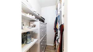 Walk in closet featuring wood finished floors
