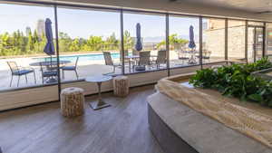 Living area with wood finished floors and healthy amount of natural light