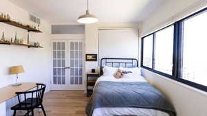 Bedroom featuring french doors and wood finished floors