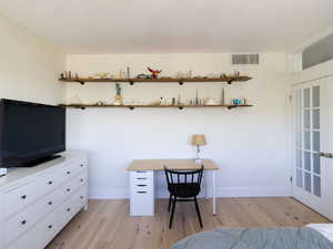 Bedroom with light wood-style flooring and baseboards