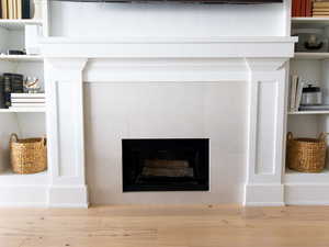 Detailed view of a fireplace and wood finished floors