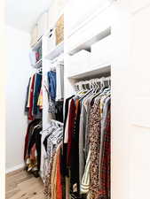 Spacious closet featuring wood finished floors