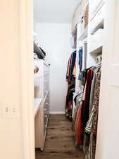Walk in closet featuring wood finished floors