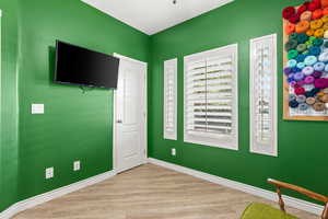 Unfurnished bedroom with baseboards and wood finished floors