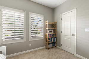 Bedroom featuring carpet flooring and baseboards