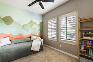 Bedroom featuring carpet, baseboards, and ceiling fan