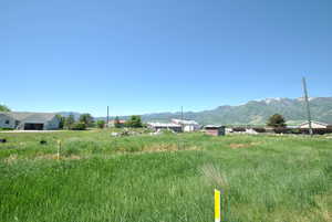 View of mountain backdrop featuring rural landscape