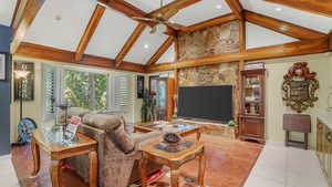 Living room featuring beamed ceiling, ceiling fan, light tile patterned flooring, baseboards, and recessed lighting