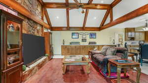 Living area featuring ceiling fan, high vaulted ceiling, beamed ceiling, and recessed lighting