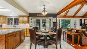 Dining room with light tile patterned floors and recessed lighting