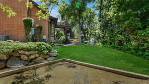 View of green lawn featuring central AC