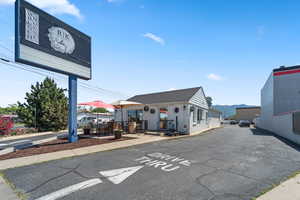 View of asphalt road featuring sidewalks and a mountain view