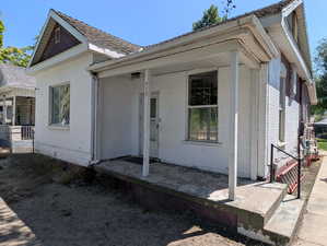 View of front of brick home with covered porch