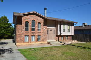 Raised ranch featuring brick siding
