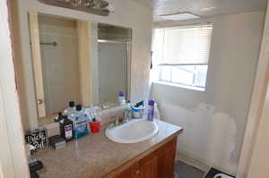 Full bathroom featuring vanity and a stall shower