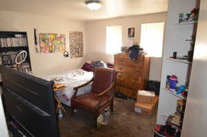Bedroom with carpet and a textured ceiling